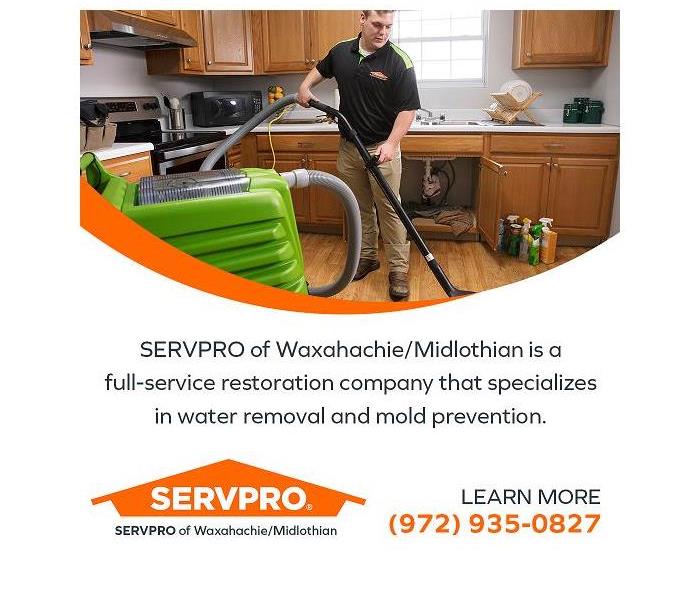 SERVPRO technician removing water from a water damaged kitchen
